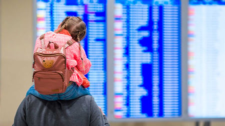 People viewing departures and arrivals at airport